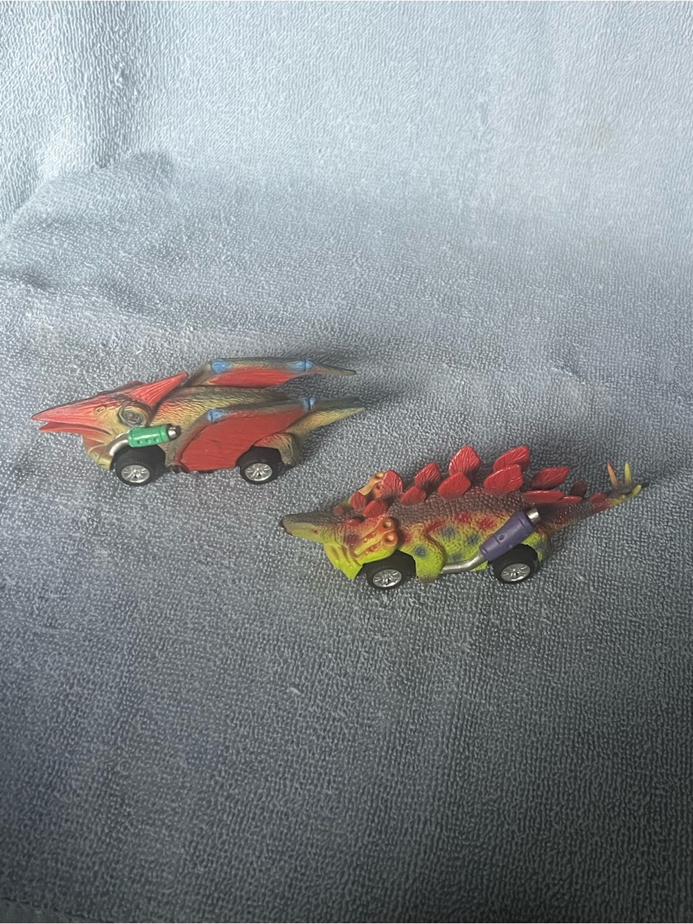 Two dinosaur pull-back toy cars